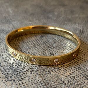Designer inspired stainless steel bracelet with 14k plating & cubic zirconia